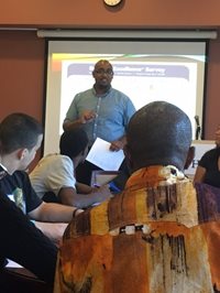 Speaker Success coach Solomon Picou. Students listening.