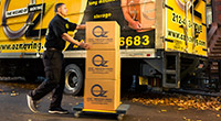 Oz Moving & Storage worker next to a truck moving boxes