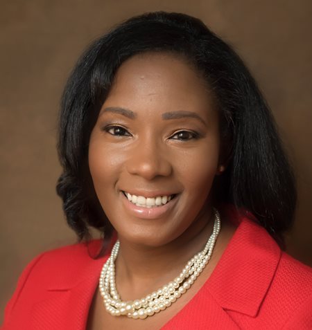 Photo of LJeffers Black hair red suit pearl necklace
