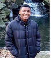 a person standing in front of a waterfall