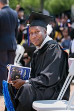 Graduating male student with cap and gown