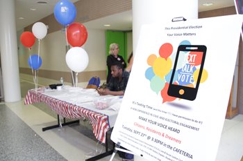 Vote registration event.  1 man 1 woman. balloons.